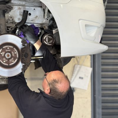 Hi Q Tewkesbury Mechanic working on wheel