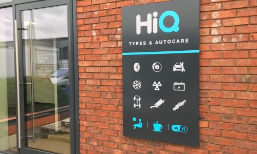 Exterior signage showing main services and facilities at HiQ Enfield