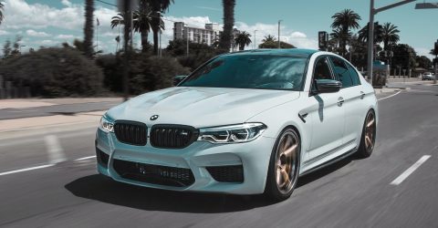 BMW M4 Light Blue with Gold Alloys Driving Through Roads with Palm Trees