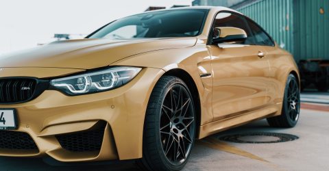 Gold BMW M4 Side Profile Parked on Truck Yard with Michelin Tyres