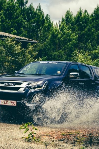 Black Isuzu driving through water