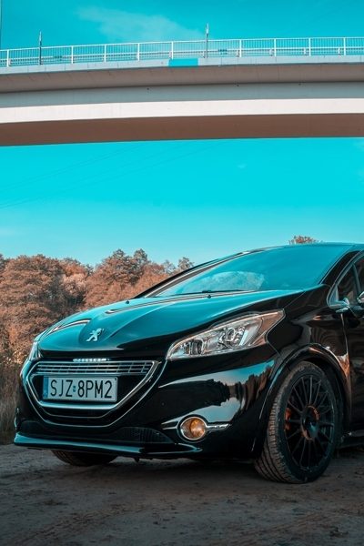 Black Peugeot under bridge