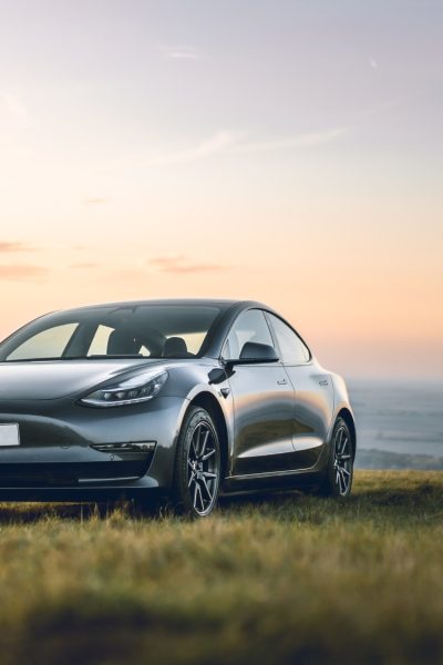 Grey Tesla and view over mountains