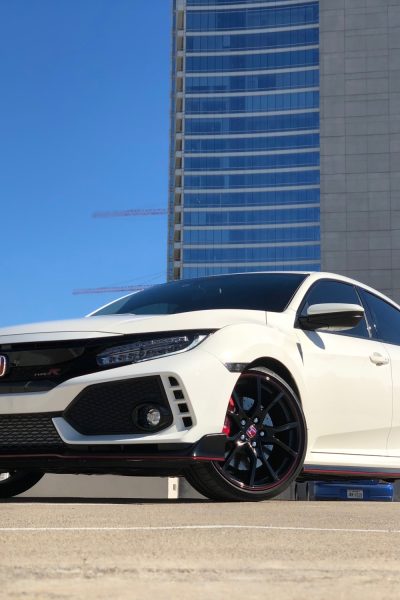 White Honda in city landscape