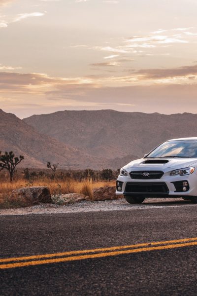 White Subaru takenin the mountains on Canon